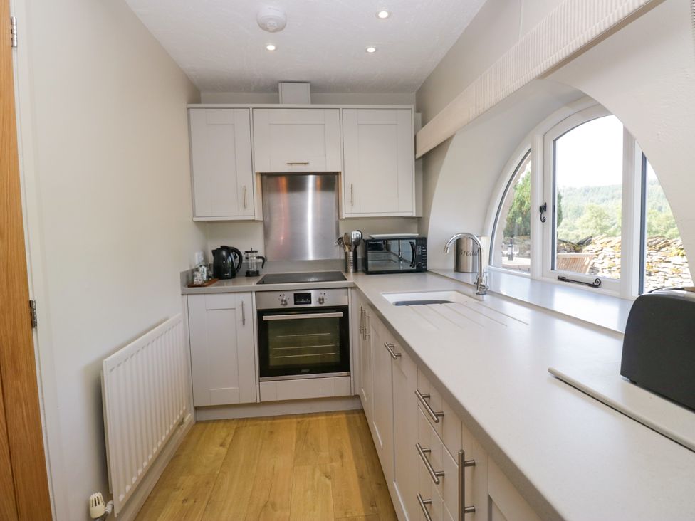 A kitchen with an oven and microwave at Windermere at the Graythwaite Estate near Hawkshead