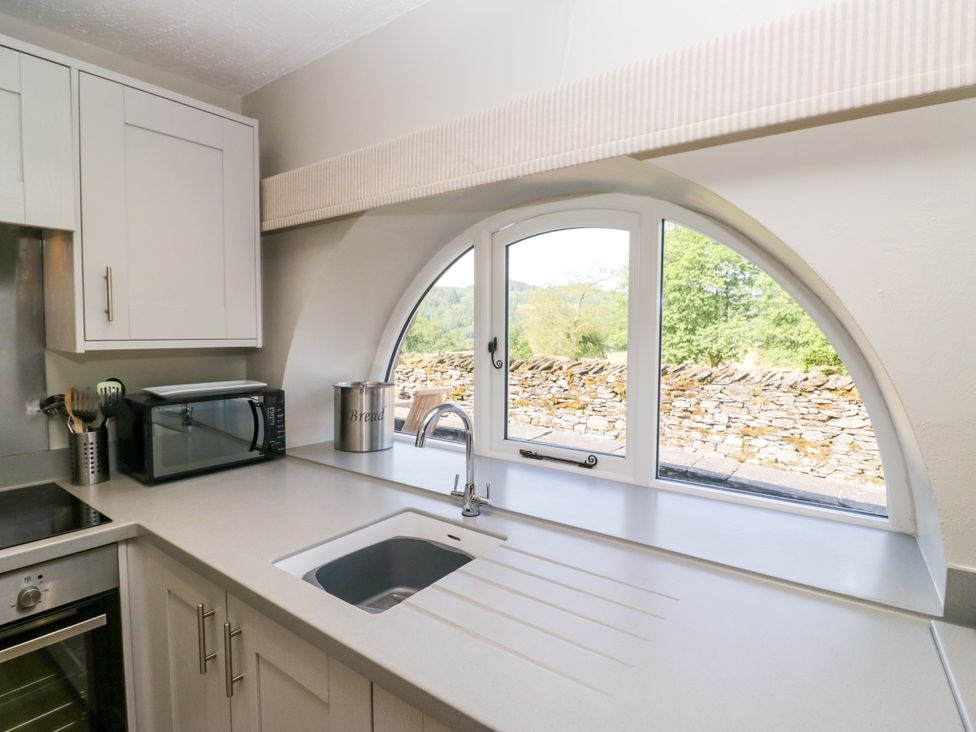 A kitchen with a sink and microwave at Windermere at the Graythwaite Estate near Hawkshead