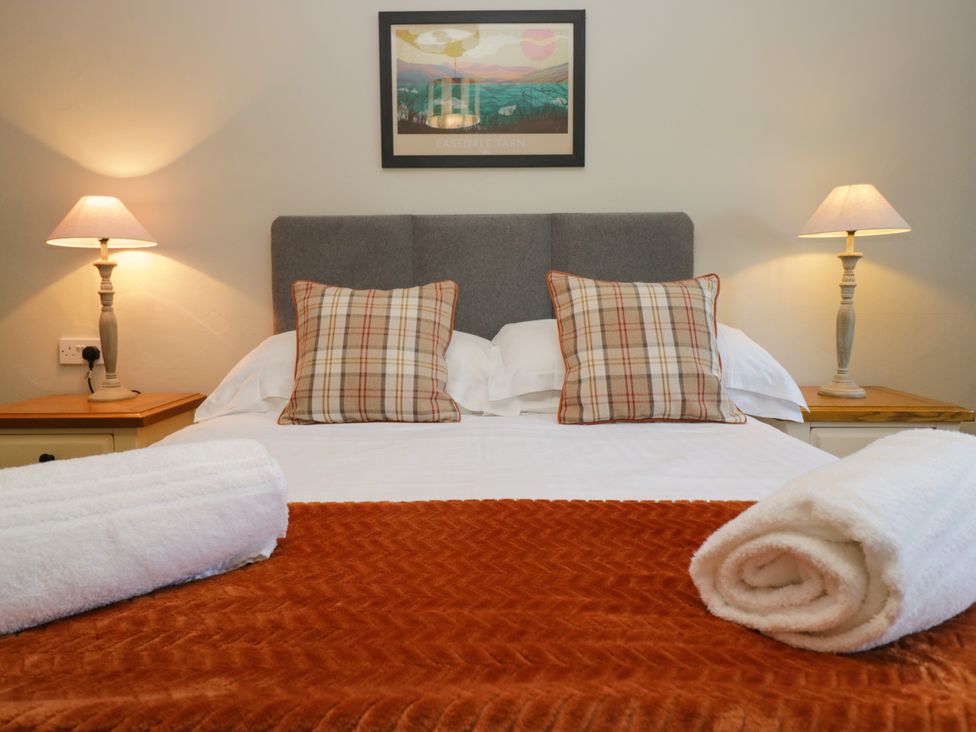 A bedroom with a bed and lamps at Windermere at the Graythwaite Estate near Hawkshead