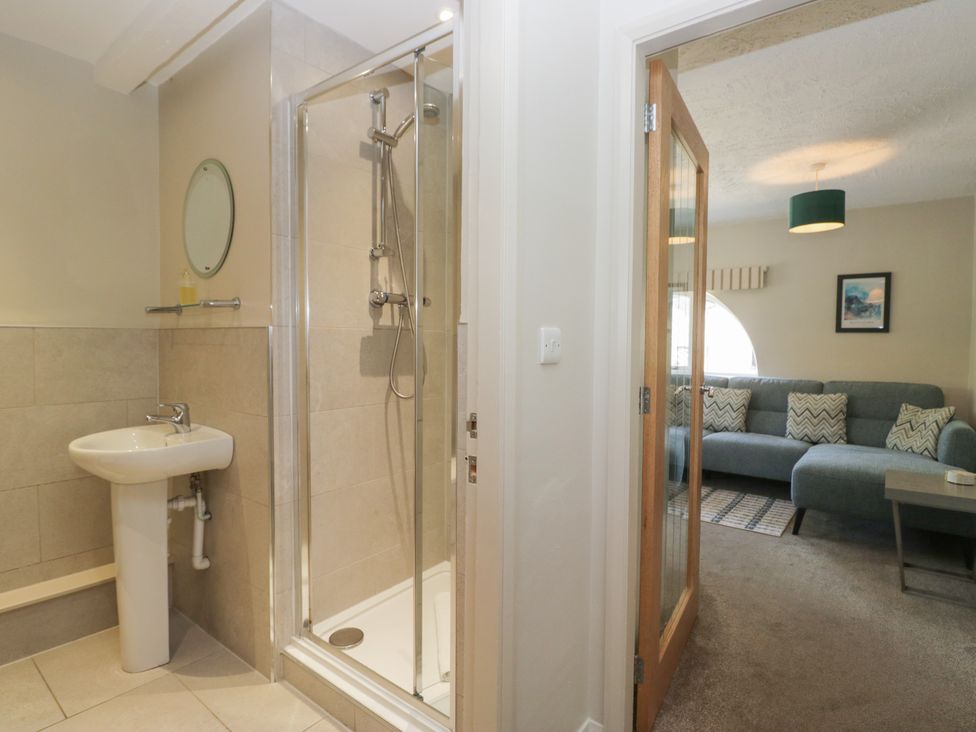 A bathroom with a shower and sink at Windermere at the Graythwaite Estate near Hawkshead