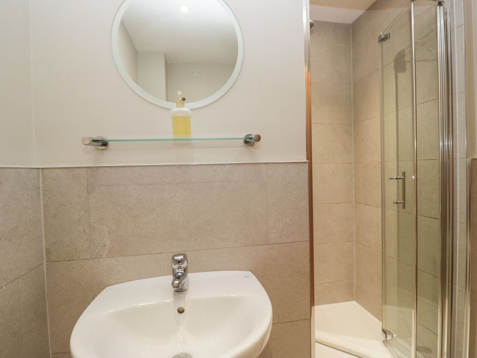 A bathroom with a sink and shower at Windermere at the Graythwaite Estate near Hawkshead
