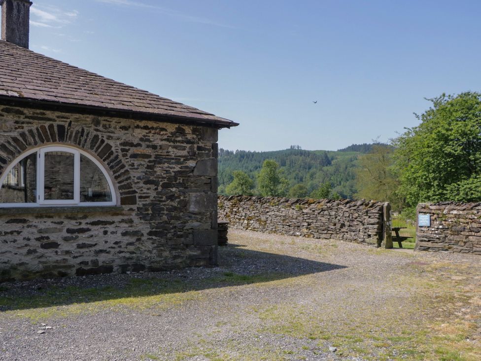 An outdoor area with a stone building and gravel path at Windermere at the Graythwaite Estate near Hawkshead
