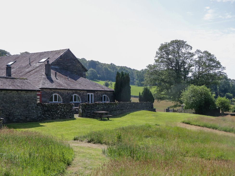 A building surrounded by grass and trees at Windermere at the Graythwaite Estate near Hawkshead