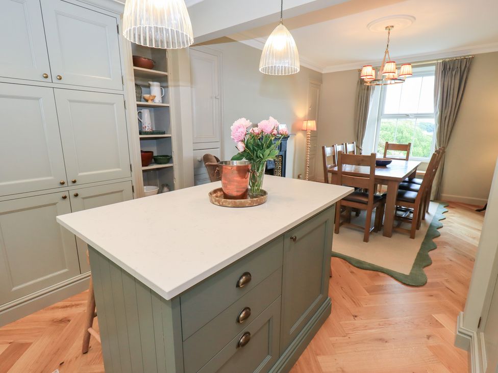 A kitchen with an island and a dining area at High Torver House in Torver