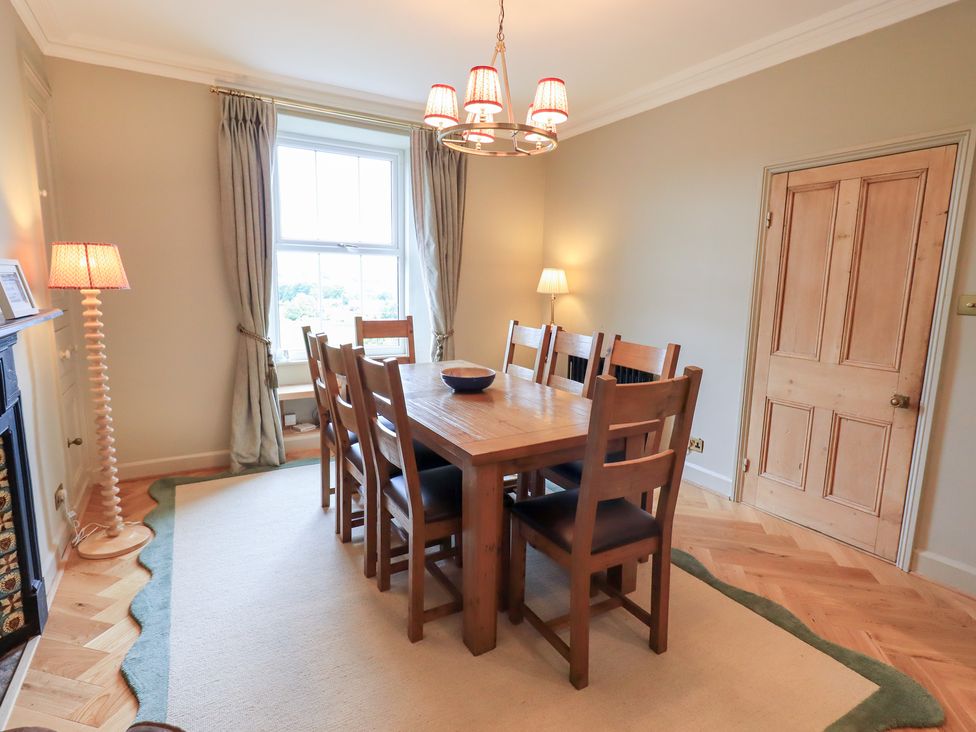 A dining room with a wooden table and chairs at High Torver House in Torver