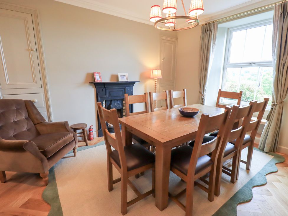 A dining room with a table and chairs at High Torver House in Torver