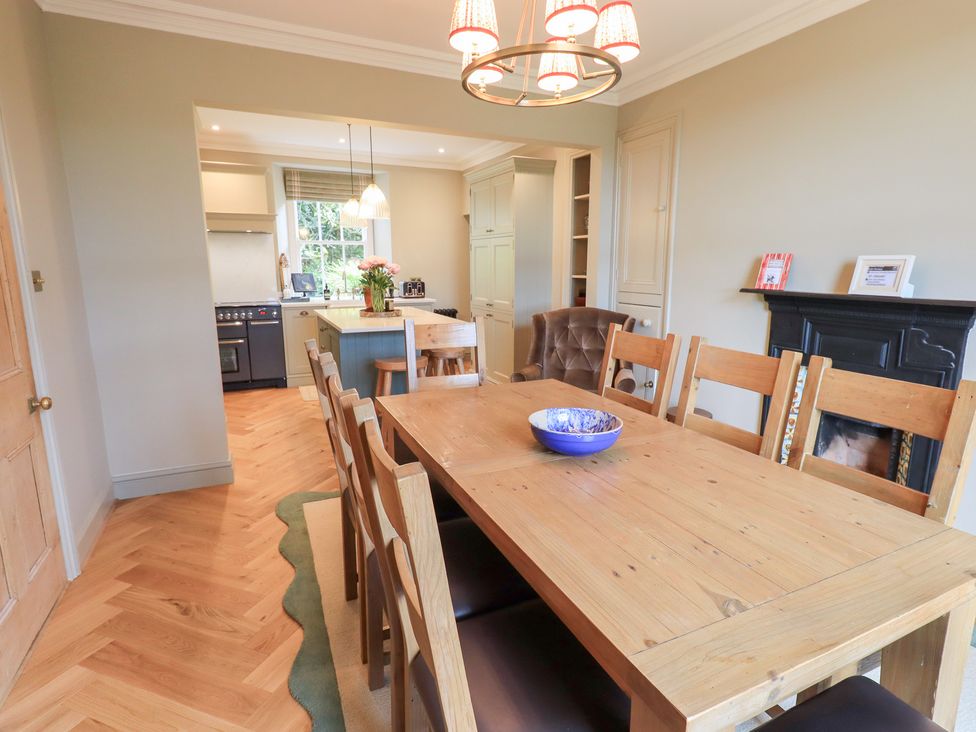 A dining room with a table and chairs at High Torver House in Torver
