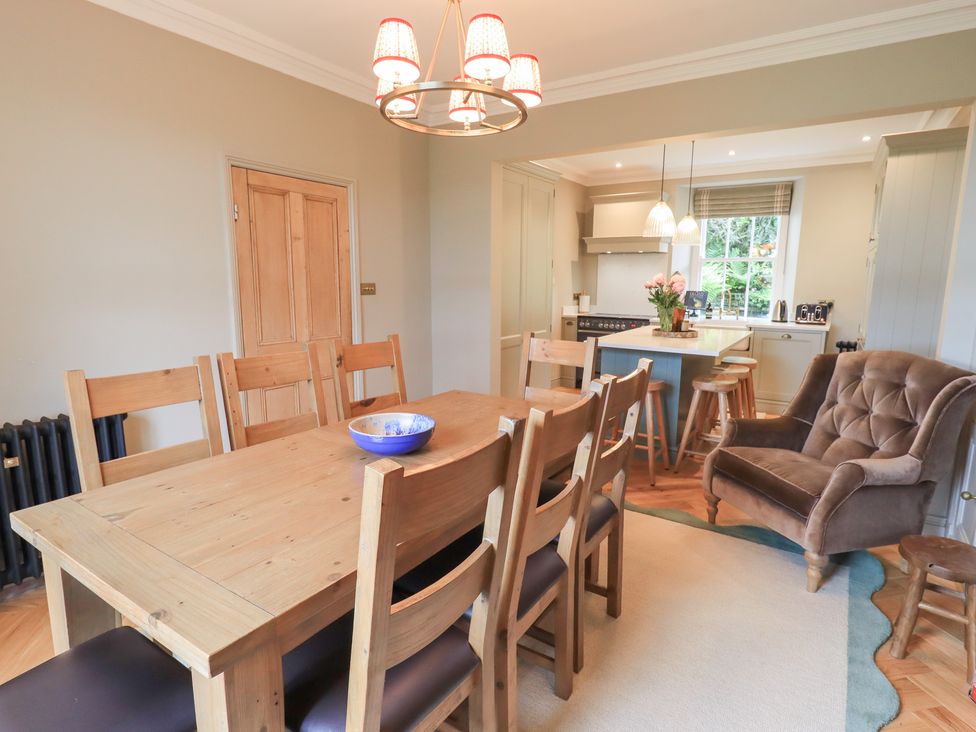 A dining room with a table and chairs at High Torver House in Torver