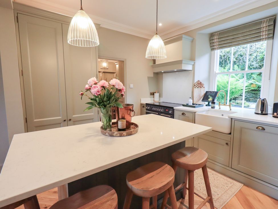 A kitchen with a sink and island at High Torver House in Torver