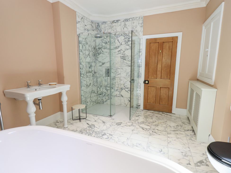 A bathroom with a shower, sink, and bathtub at High Torver House in Torver