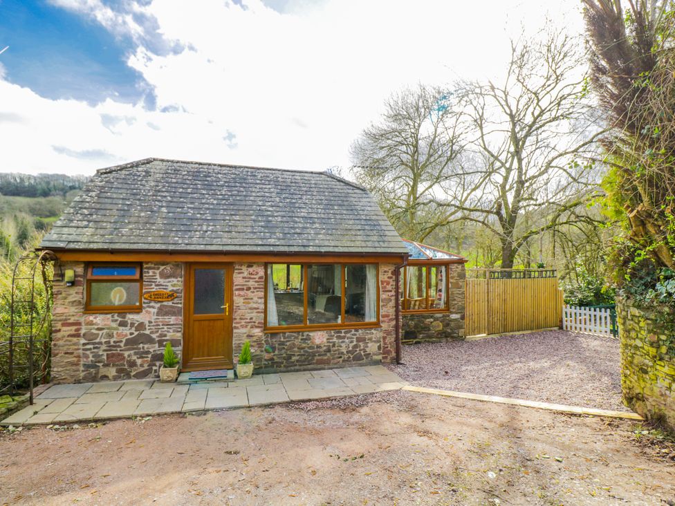 A house with stone walls and a patio at Calcott Annexe in Whitchurch, Herefordshire