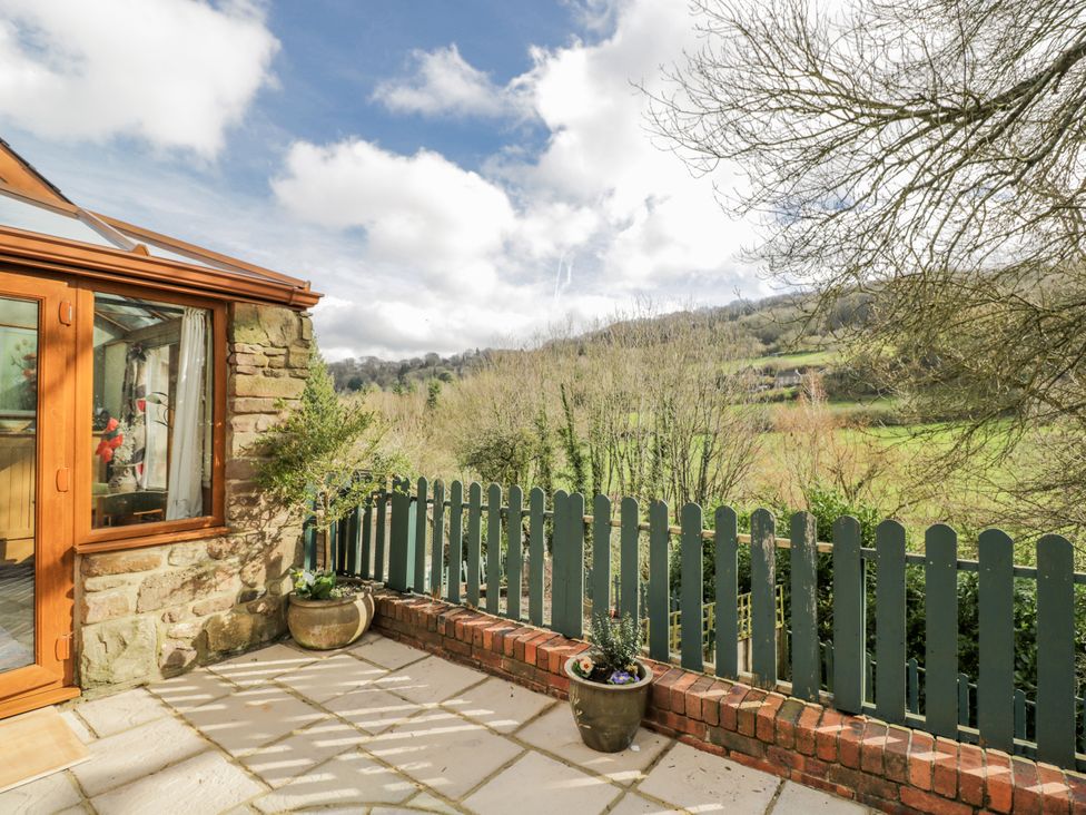 An outdoor area with a conservatory and a view of the landscape at Calcott Annexe Whitchurch Herefordshire