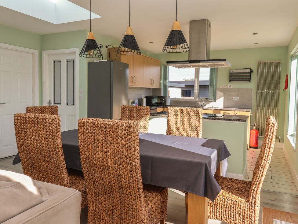 A kitchen with a dining table and chairs at Bluebell Wood in Brandesburton
