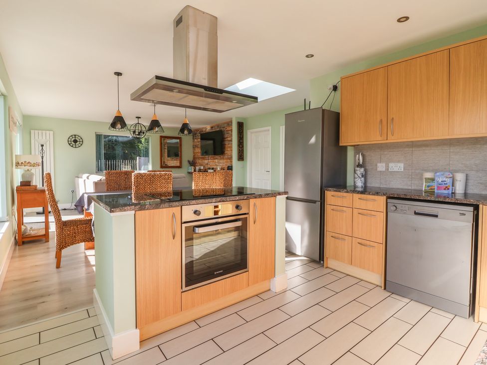 A kitchen with an island and appliances at Bluebell Wood in Brandesburton
