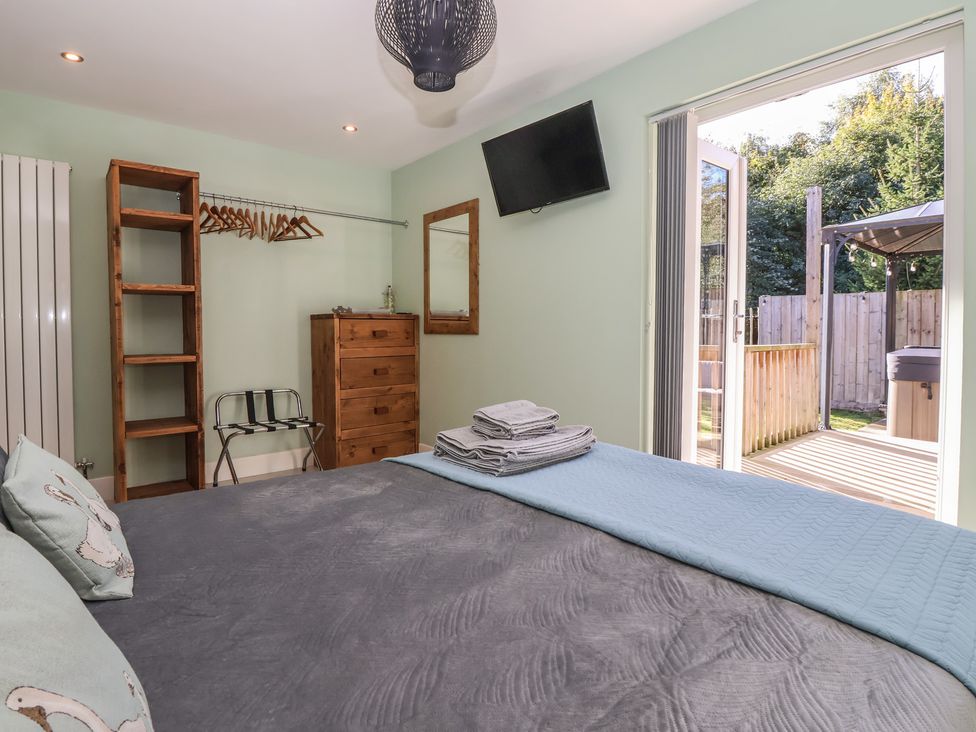 A bedroom with a bed and dresser at Bluebell Wood in Brandesburton