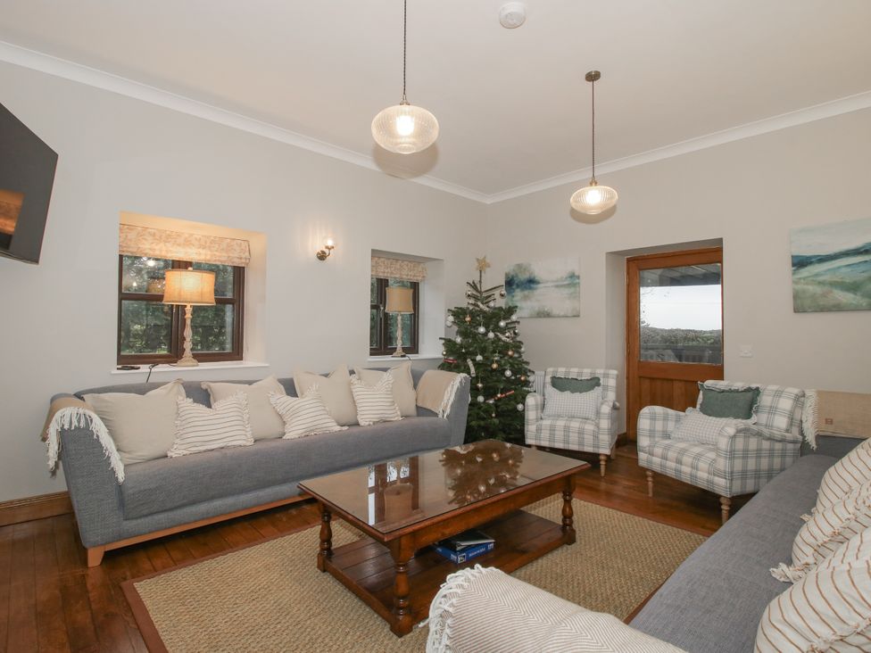 A living room with a sofa and Christmas tree at The Park in Ludlow