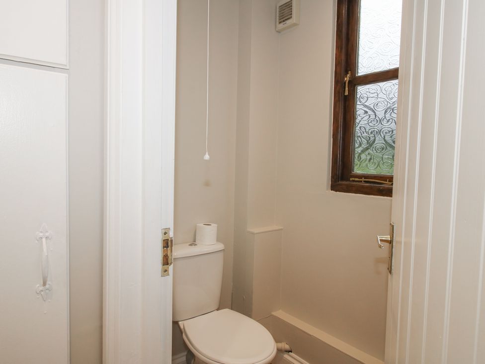 A bathroom with a toilet and a window at The Park in Ludlow