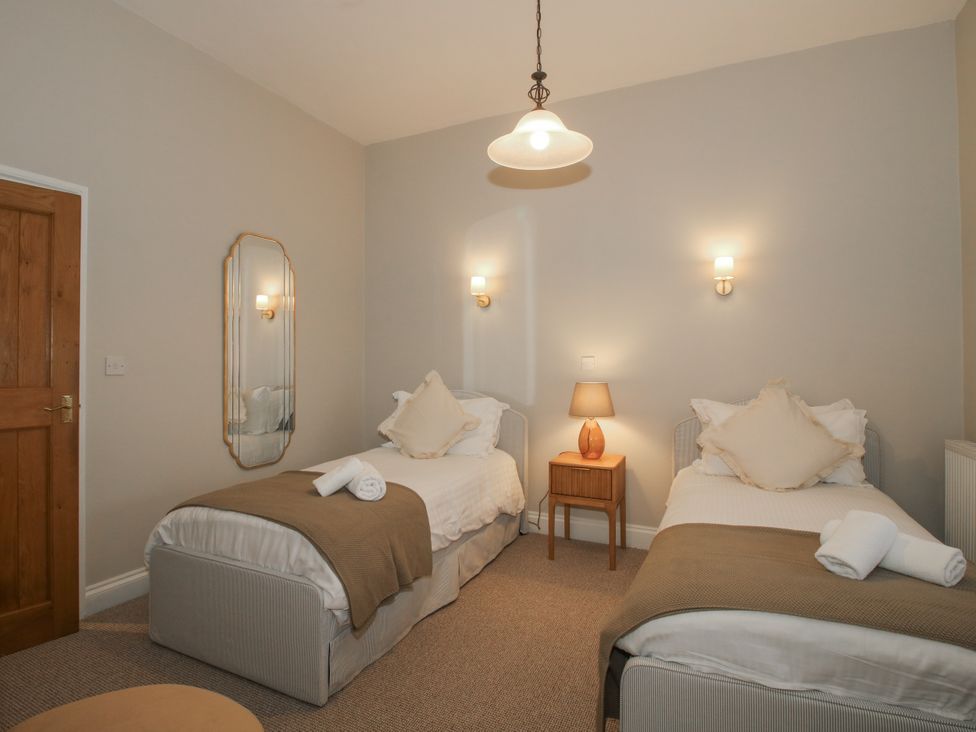 A bedroom with two beds and a table at The Park in Ludlow