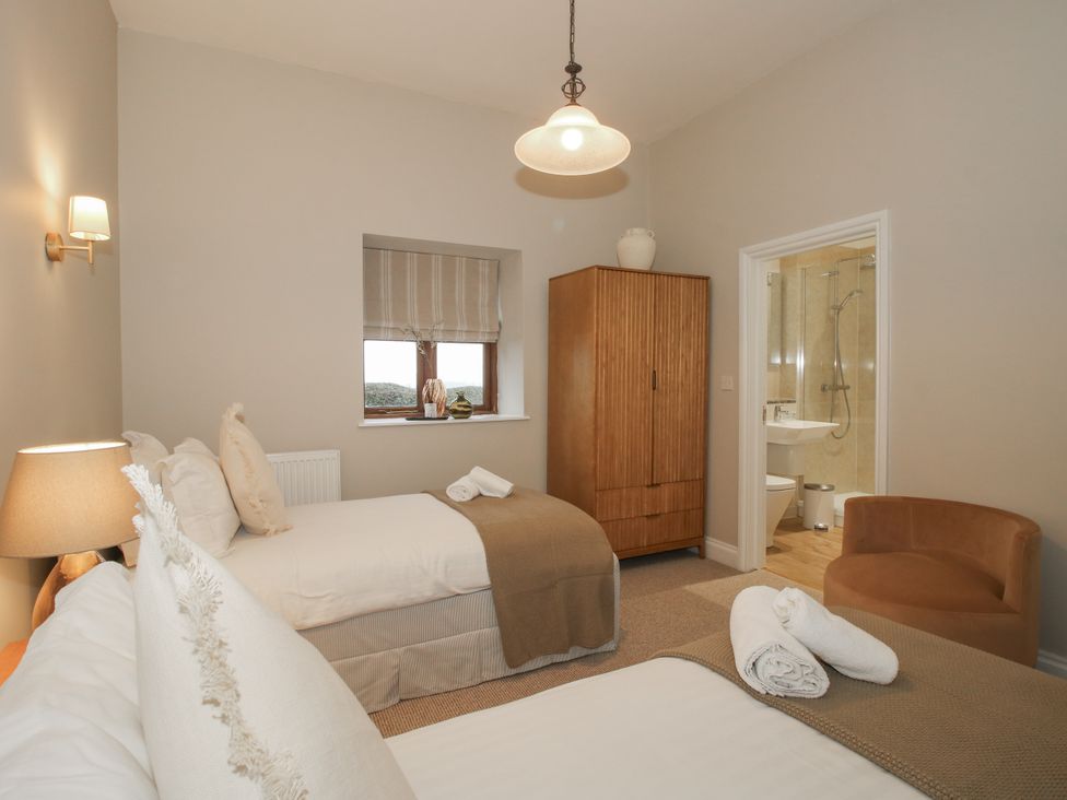 A bedroom with two beds and a cabinet at The Park in Ludlow