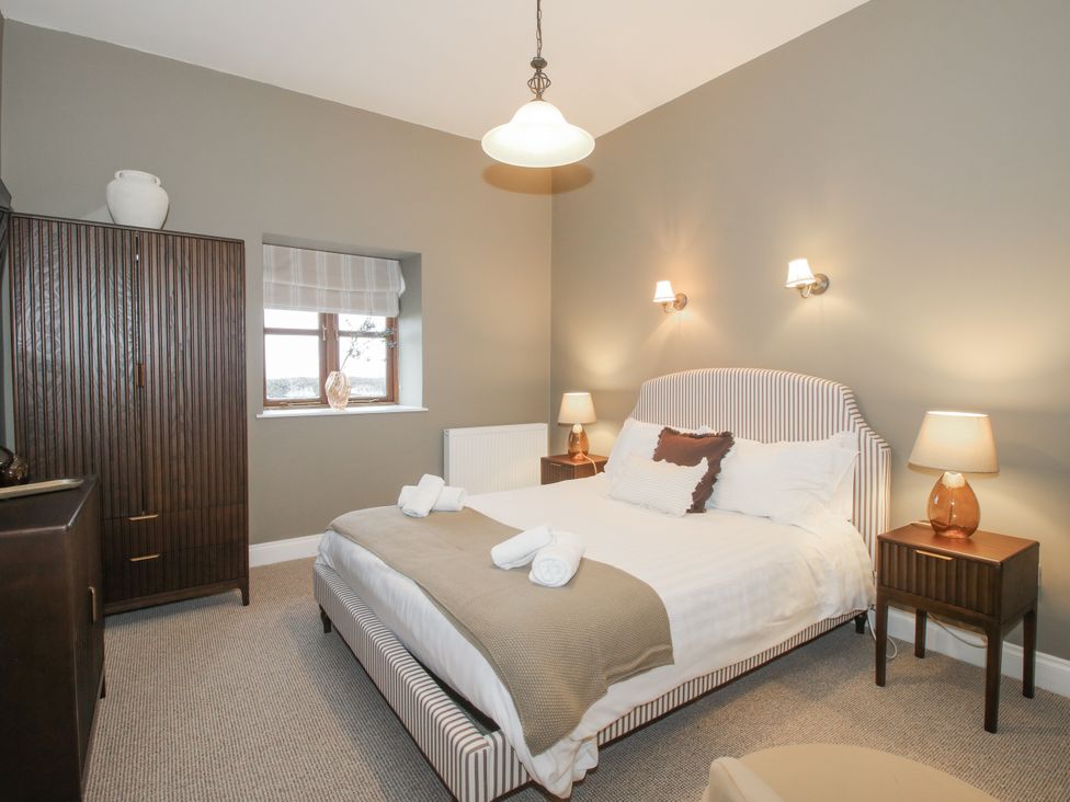 A bedroom with a bed and nightstands at The Park in Ludlow