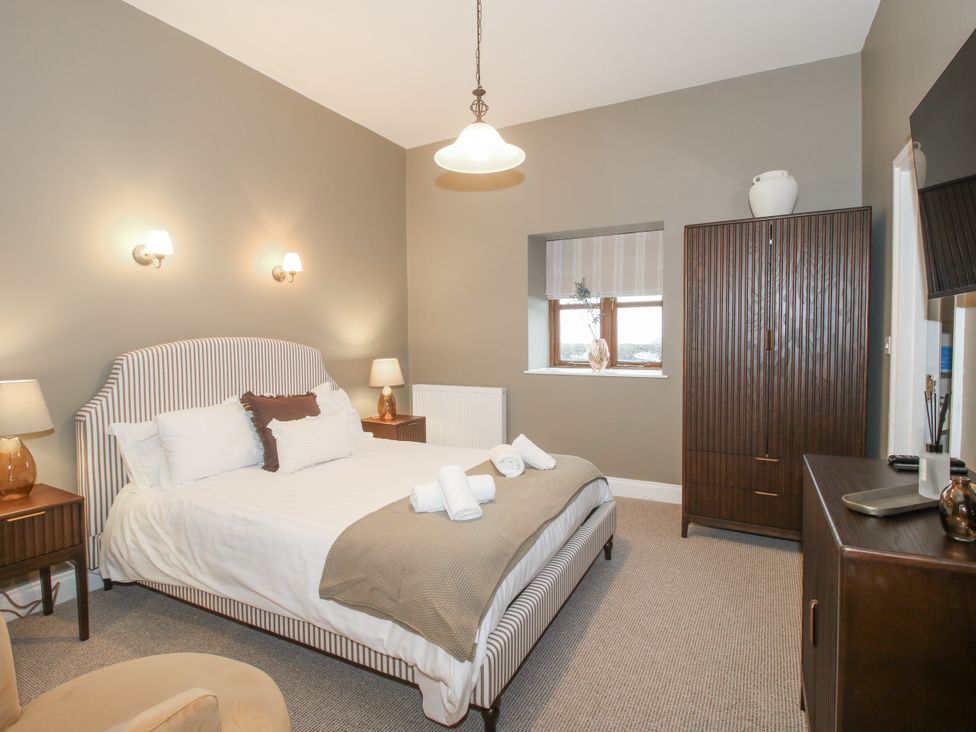 A bedroom with a bed, nightstand and wardrobe at The Park in Ludlow