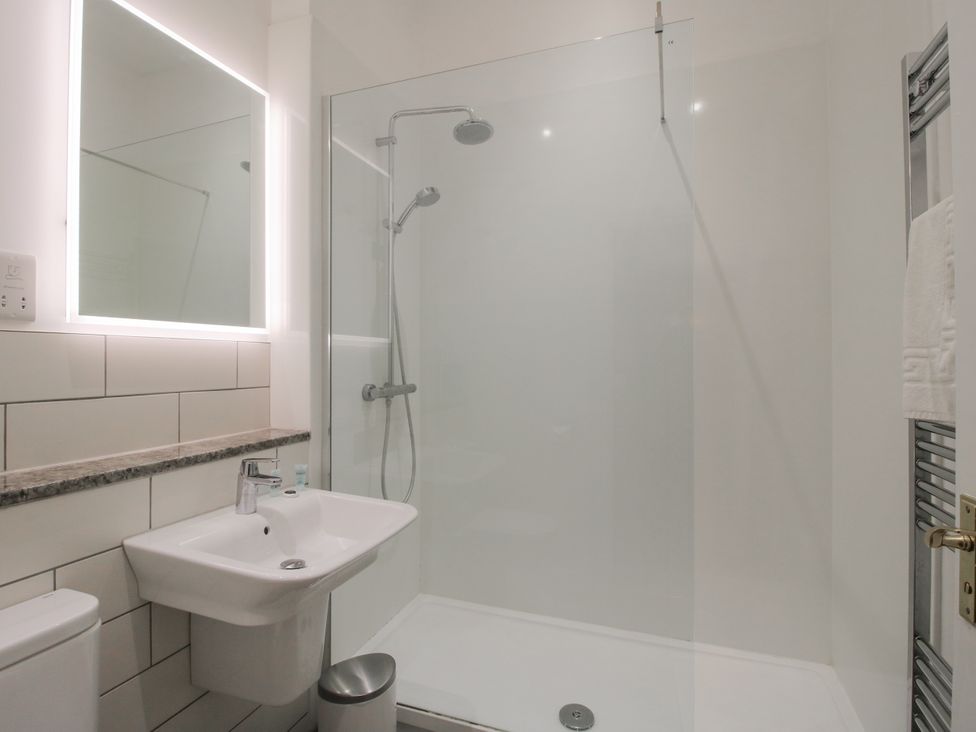 A bathroom with a shower, sink and toilet at The Park in Ludlow