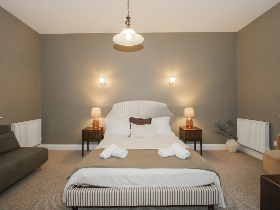 A bedroom with a double bed and a sofa at The Park in Ludlow