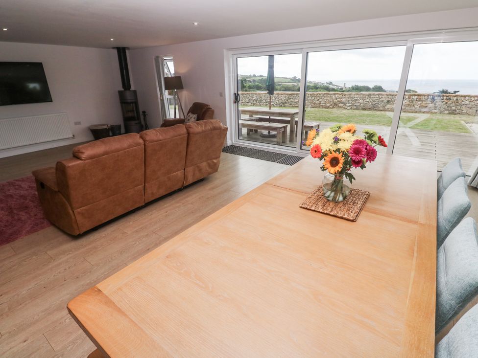A living room with a sofa and dining table at Atlantic View in Germoe