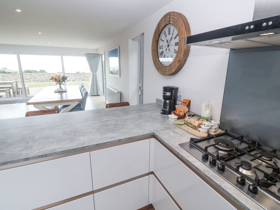 A kitchen with a counter gas stove and coffee maker at Atlantic View in Germoe