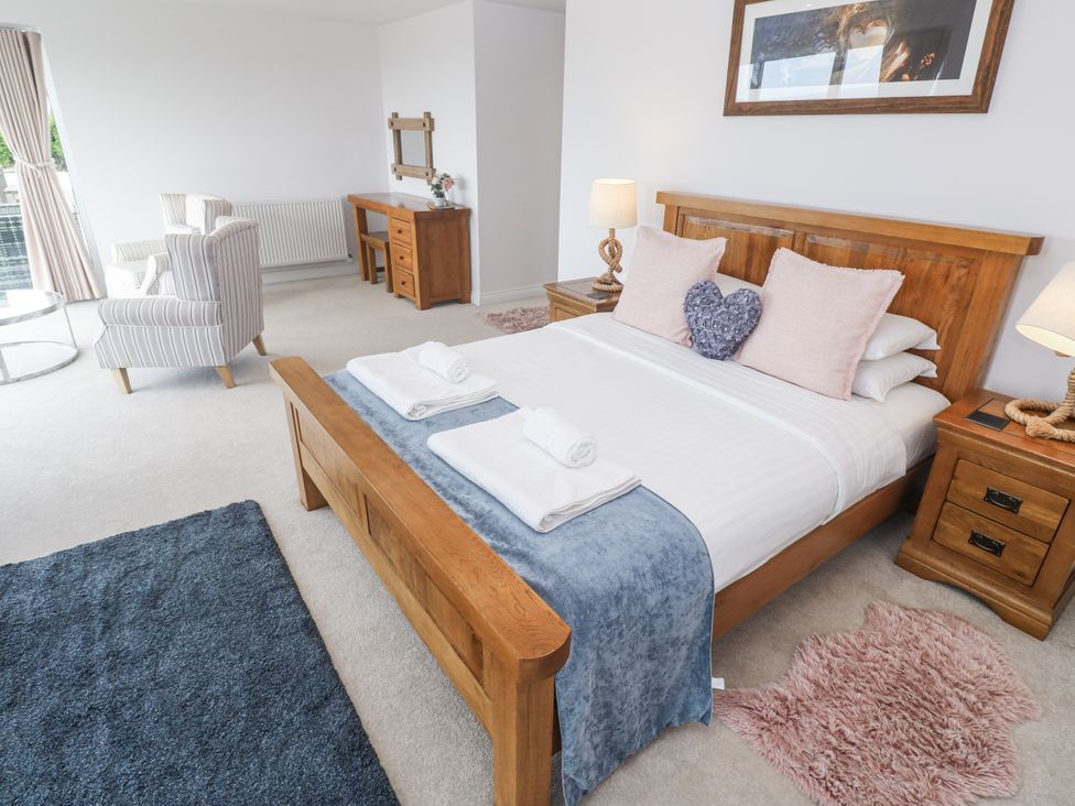 A bedroom with a bed and furniture at Atlantic View in Germoe