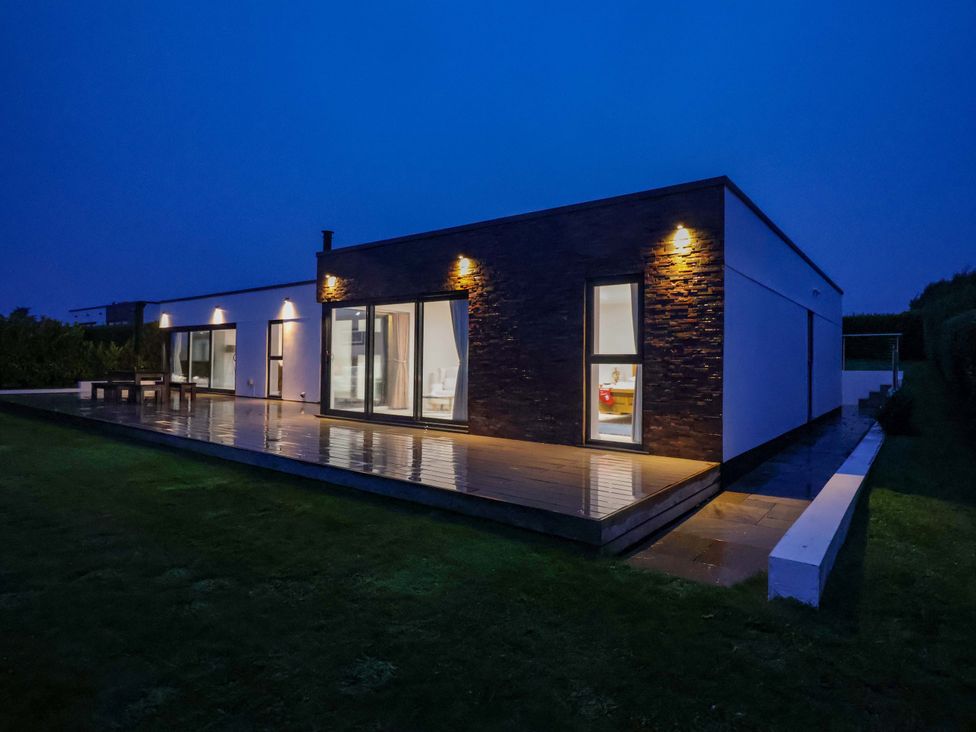 A house with a deck and sliding doors in Germoe