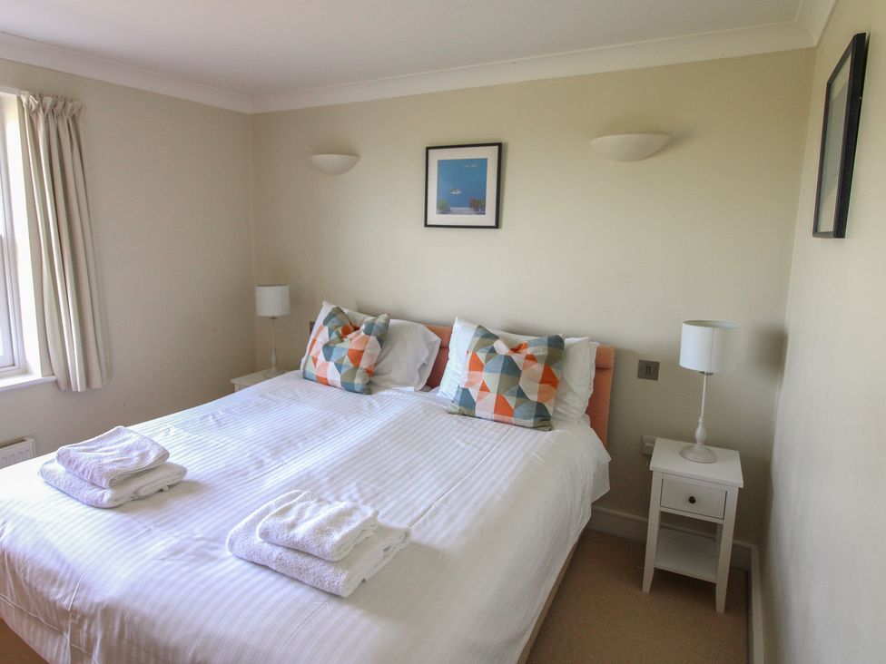 A bedroom with a double bed and bedside lamps at 4 Thurlestone Beach House in South Milton near Thurlestone