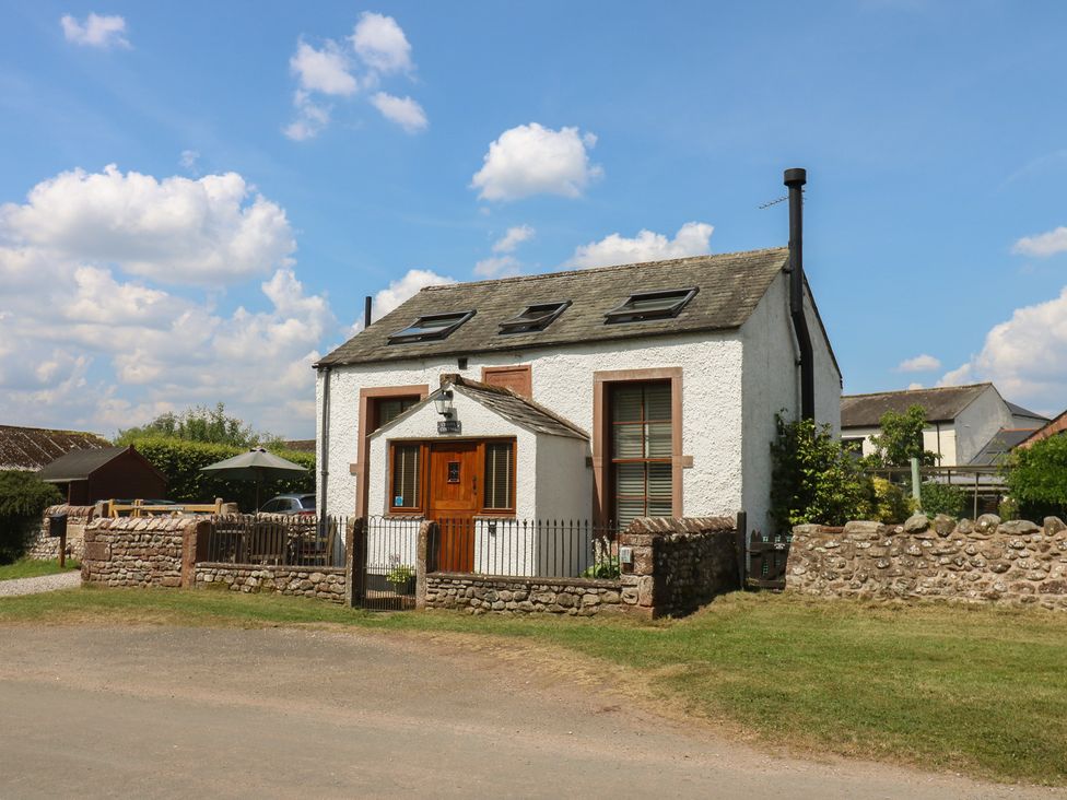 A house with a fence and garden at Chapel Cottage in Sandford, Cumbria