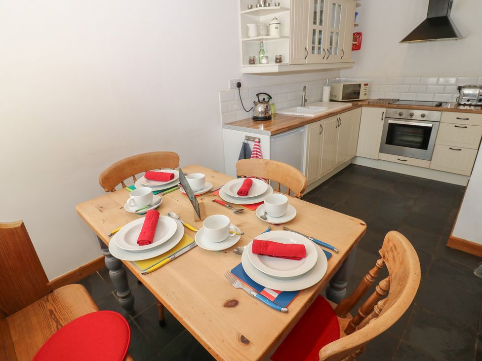 A kitchen with a dining table set for four at Chapel Cottage Sandford, Cumbria