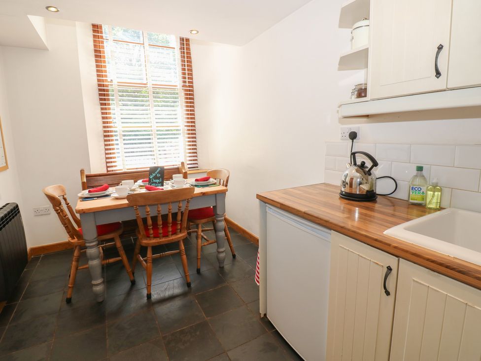 A kitchen with a dining table and chairs at Chapel Cottage Sandford, Cumbria