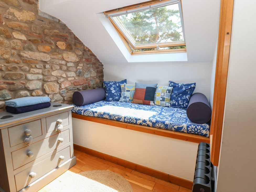 A snug room with a seating area and storage at Chapel Cottage in Sandford, Cumbria