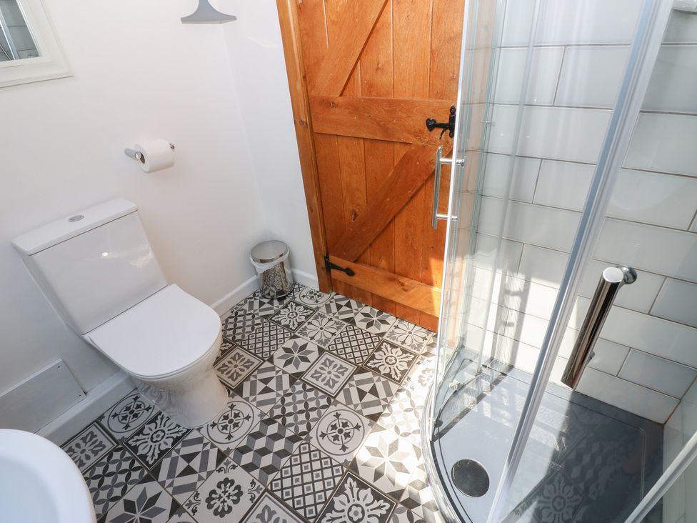 A bathroom featuring a toilet and shower at Chapel Cottage in Sandford, Cumbria