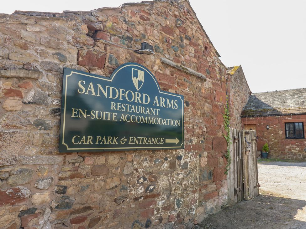 A sign for Sandford Arms restaurant and accommodation at Chapel Cottage Sandford, Cumbria