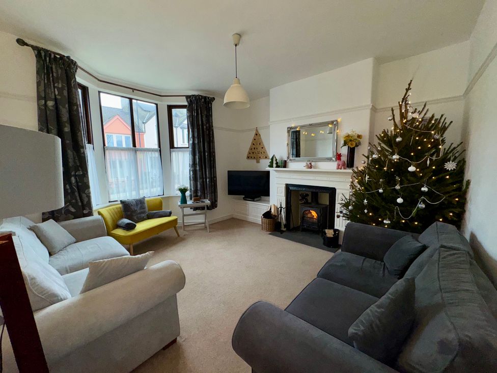 A living room with a sofa and Christmas tree at Monfa in Cemaes Bay