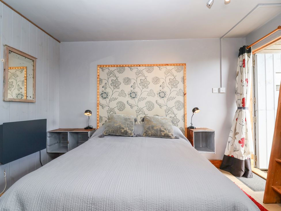 A bedroom with a bed and bedside tables at Tiny Willow in Farrington near Child Okeford