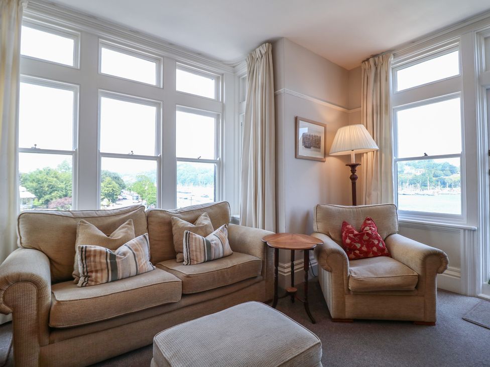 A living room with a sofa and armchair at 2 York House in Dartmouth