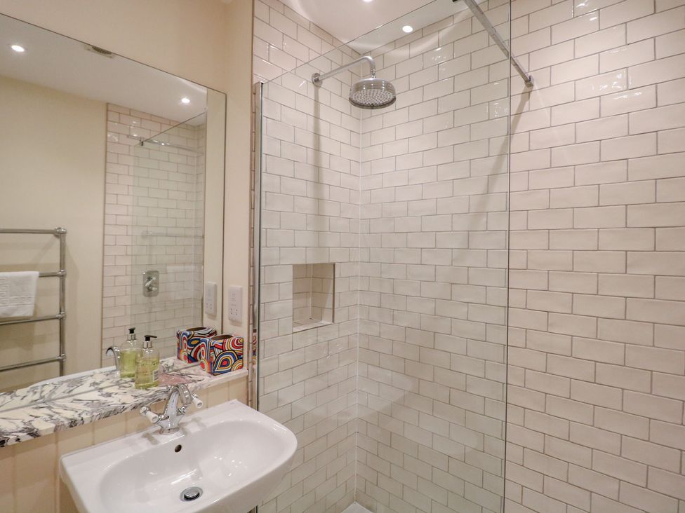 A bathroom with a shower and a sink at 2 York House Dartmouth