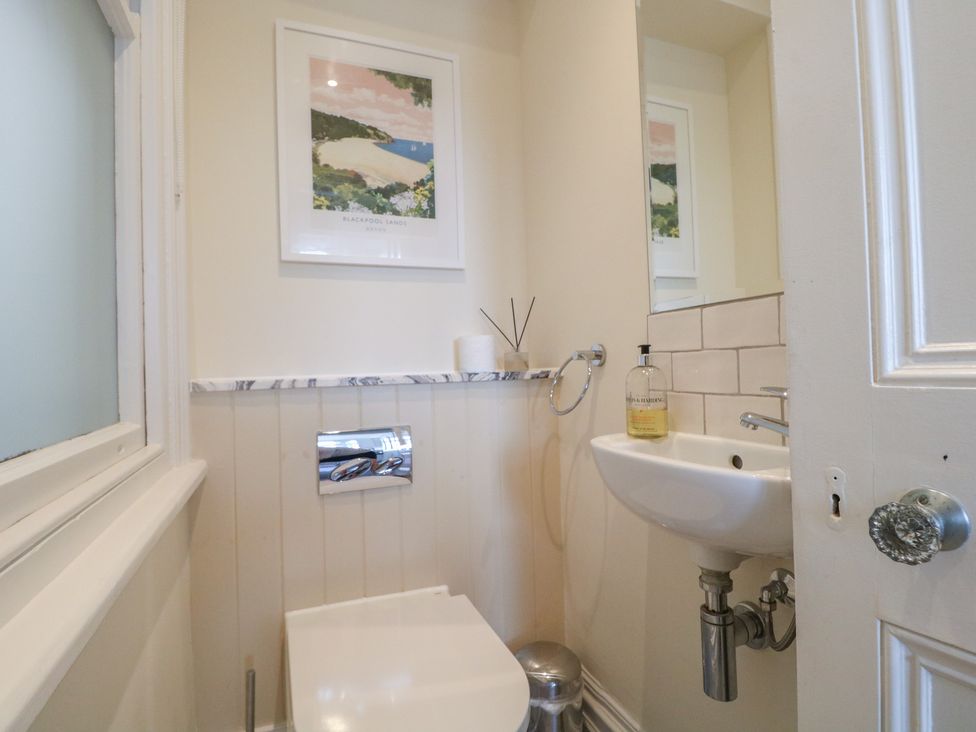 A bathroom with a toilet and sink at 2 York House in Dartmouth