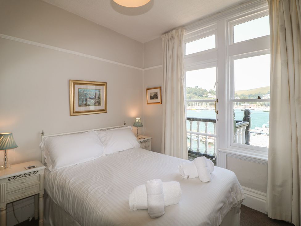A bedroom with a bed and window view at 2 York House in Dartmouth