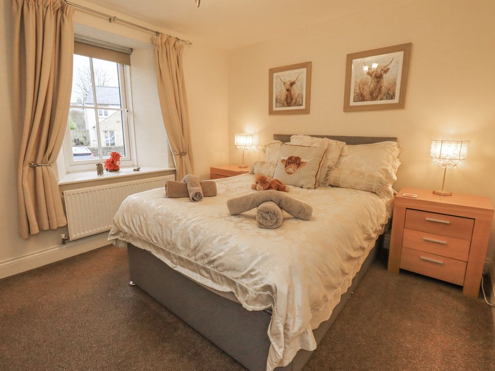 A bedroom with a bed and bedside tables at Old Bridge Inn Ingleton