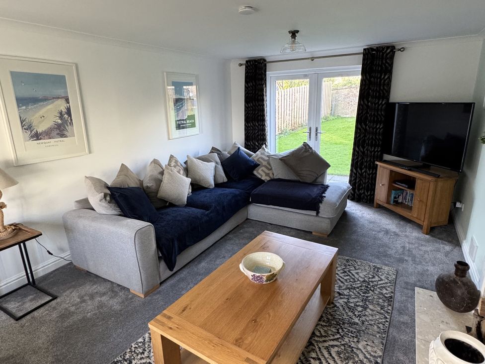 A living room with a sofa and coffee table at Fistral Bay Cottage in Newquay