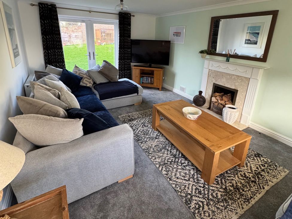 A living room with a sofa and television at Fistral Bay Cottage in Newquay