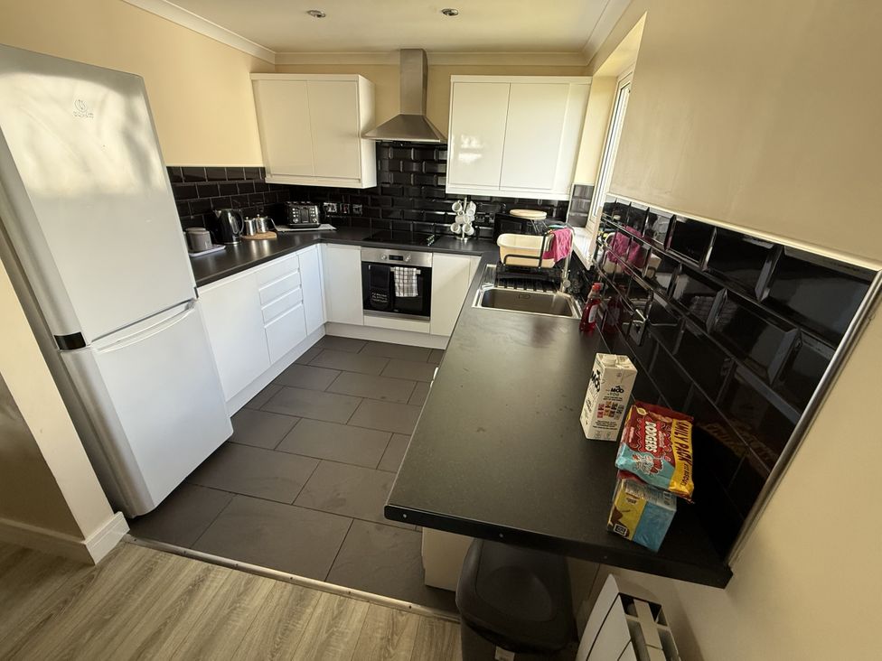 A kitchen with a refrigerator sink and kitchen cabinets at Hembry Meadows near Honicombe Park near Gunnislake