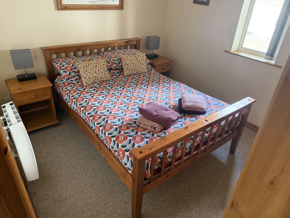 A bedroom with a bed and bedside tables at Hembry Meadows Honicombe Park near Gunnislake