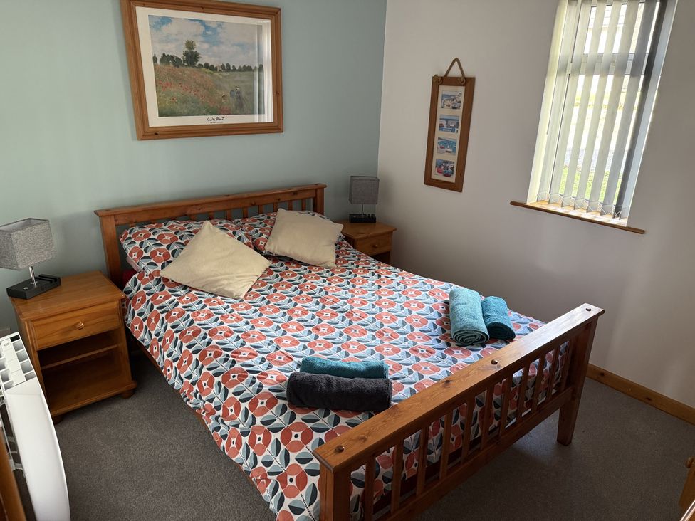A bedroom with a bed and bedside table at Hembry Meadows near Gunnislake